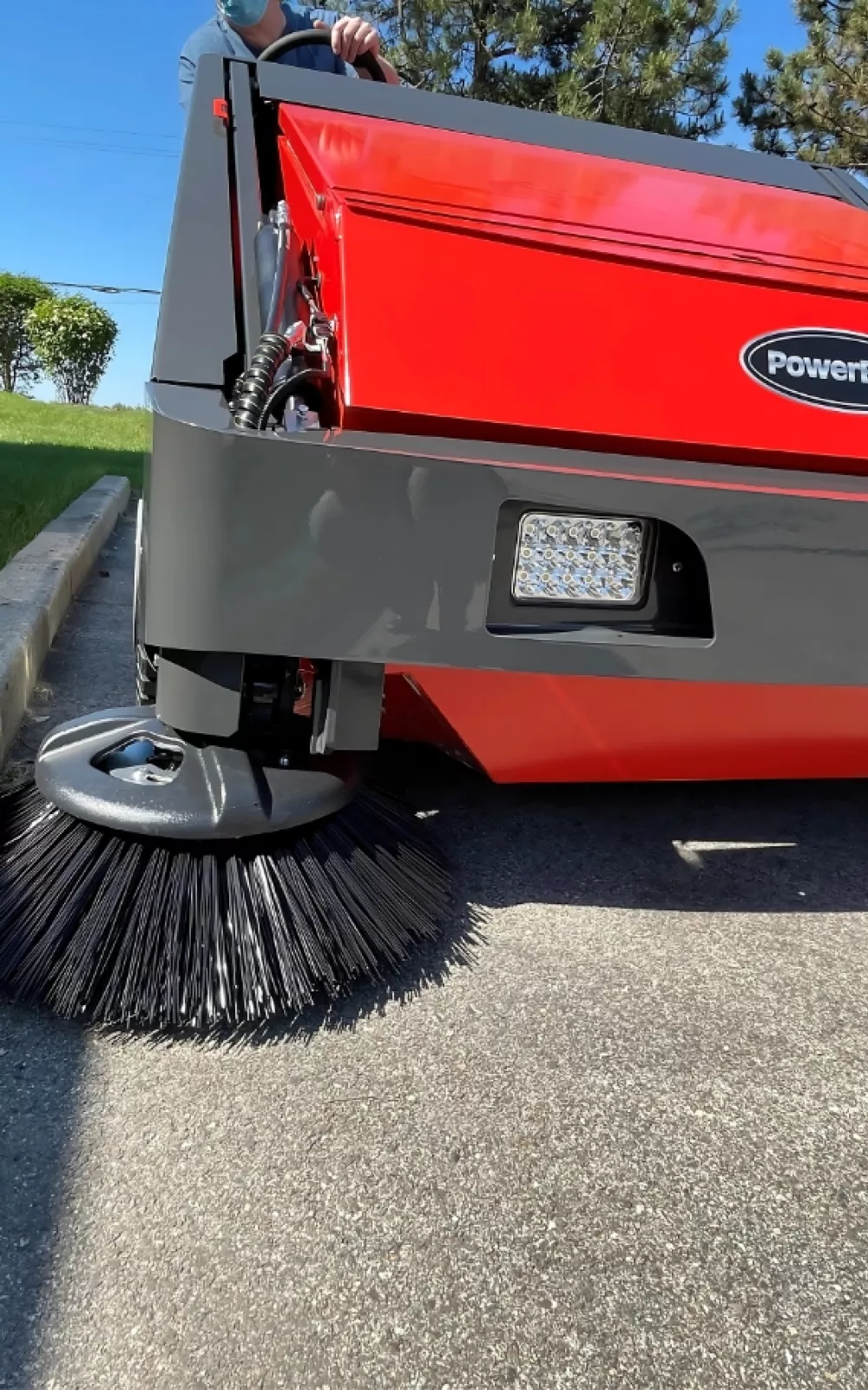 PowerBoss Armadillo industrial cleaning sweeper and brush cleaning the street.