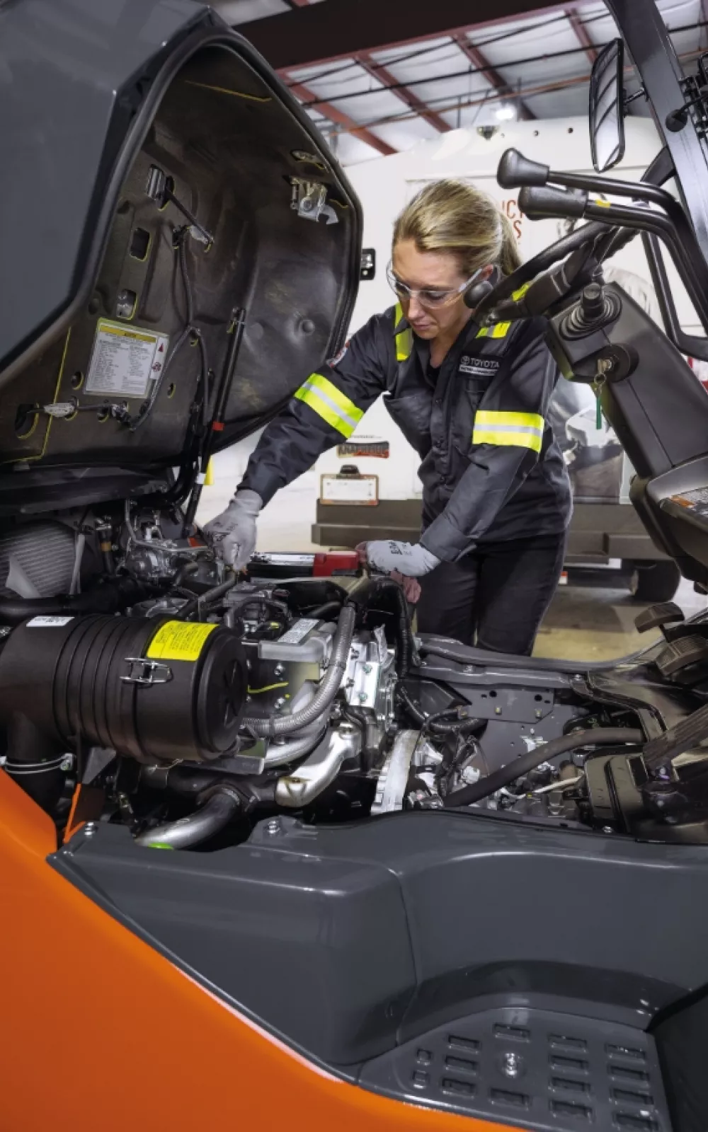 Toyota service technician doing forklift service.